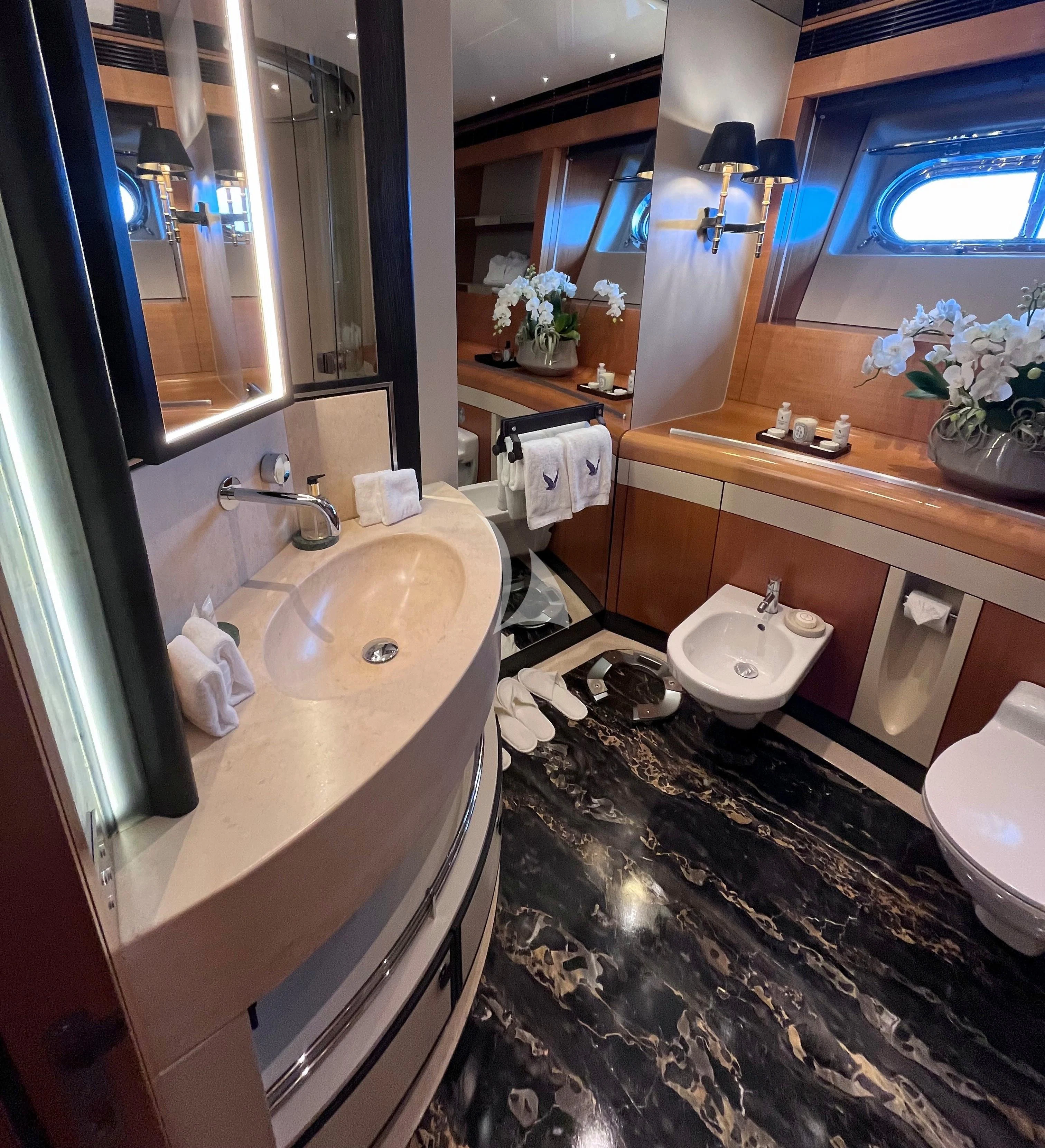 a bathroom with a tub sink and toilet aboard MALTESE FALCON Yacht for Sale