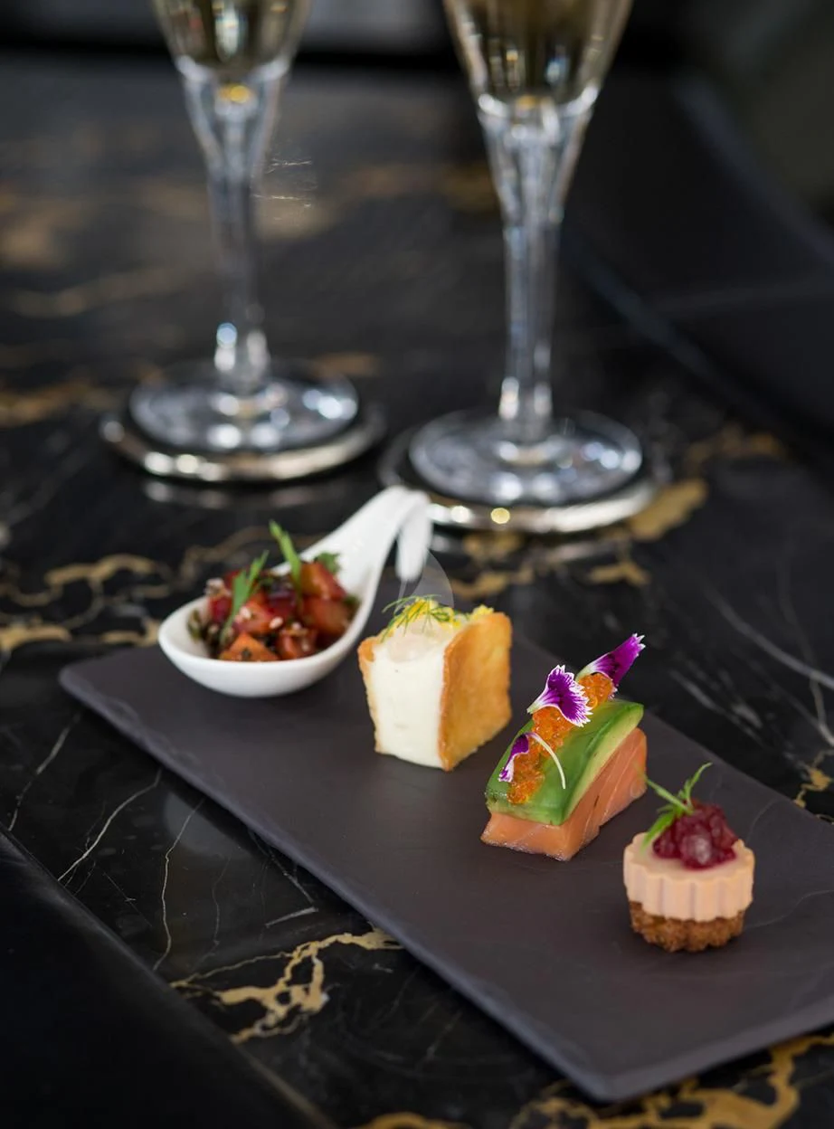 a plate of desserts and glasses aboard MALTESE FALCON Yacht for Sale