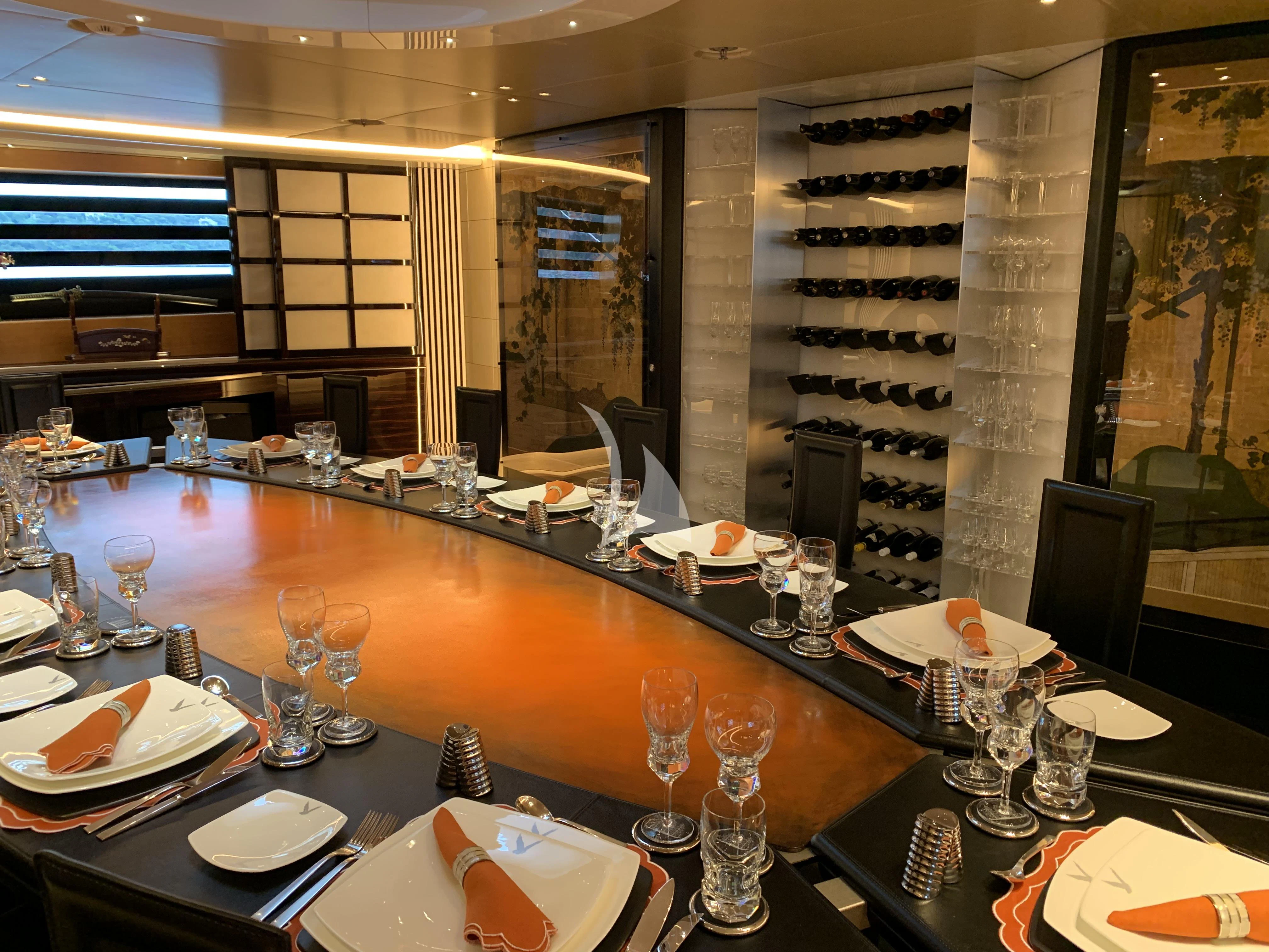 a large table with empty glasses aboard MALTESE FALCON Yacht for Sale
