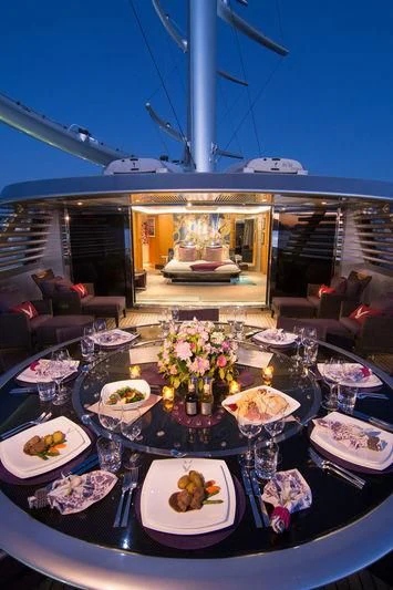 a table with plates and food on it aboard MALTESE FALCON Yacht for Sale