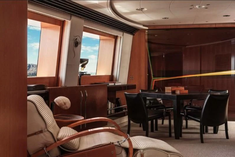 a room with a table chairs and a window aboard MALTESE FALCON Yacht for Sale