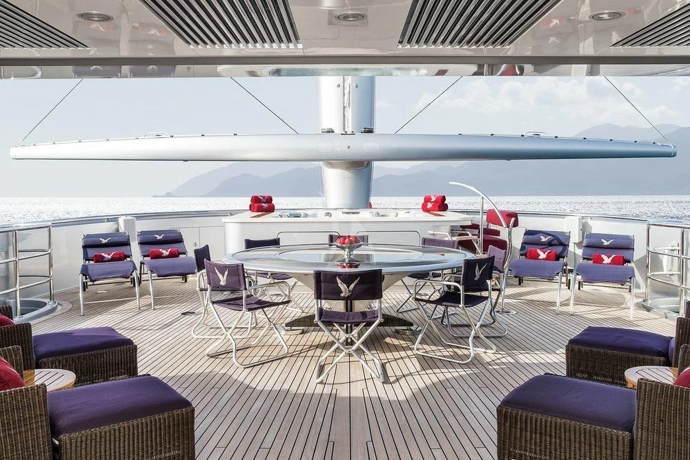 a pool with chairs and tables aboard MALTESE FALCON Yacht for Sale
