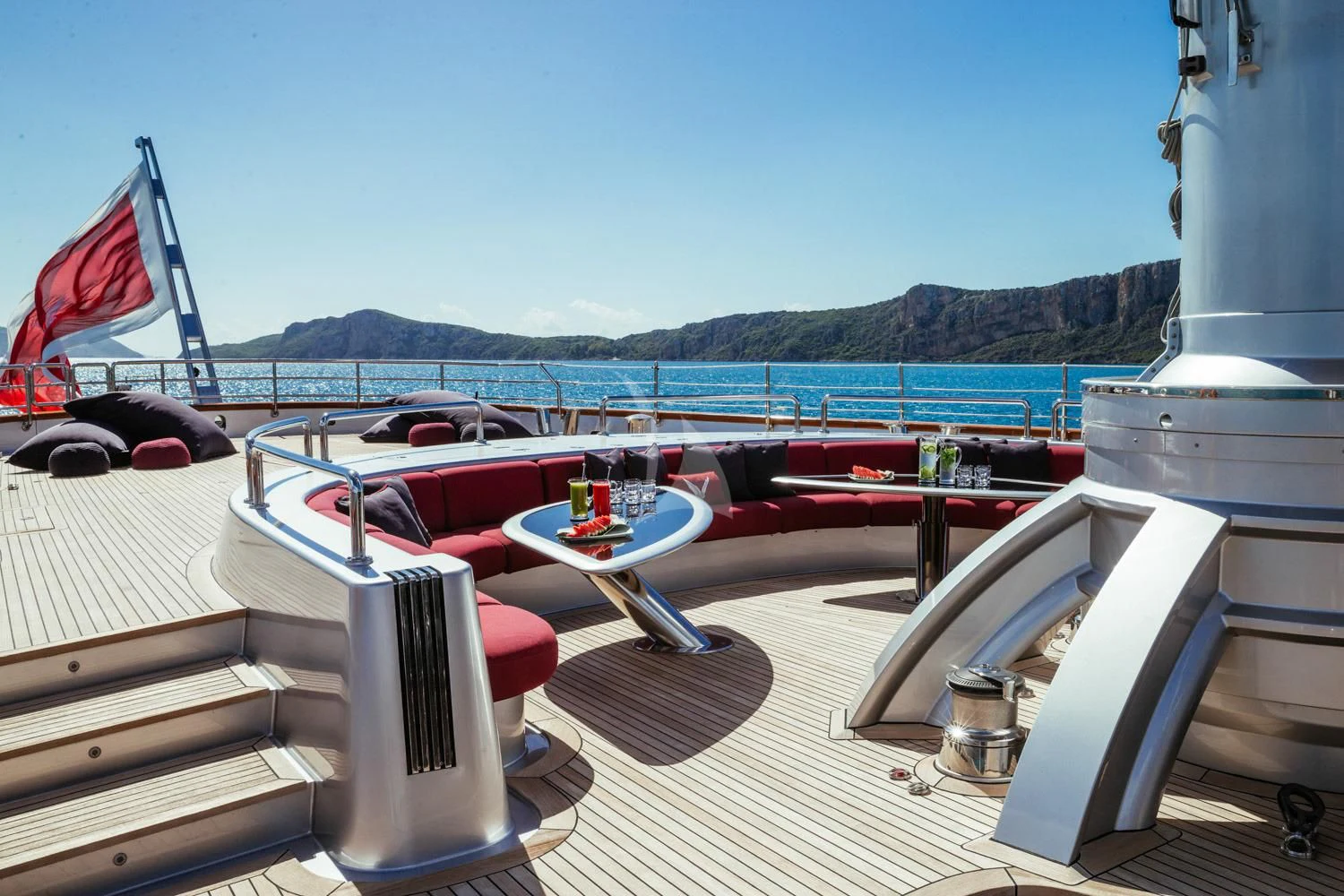 a deck with a table and chairs on it aboard MALTESE FALCON Yacht for Sale
