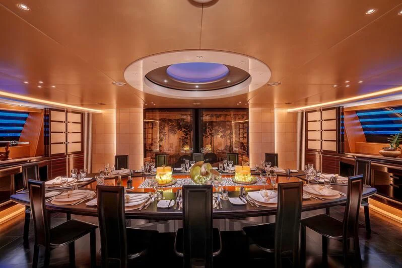 a large dining room with a large table set for a meal aboard MALTESE FALCON Yacht for Sale