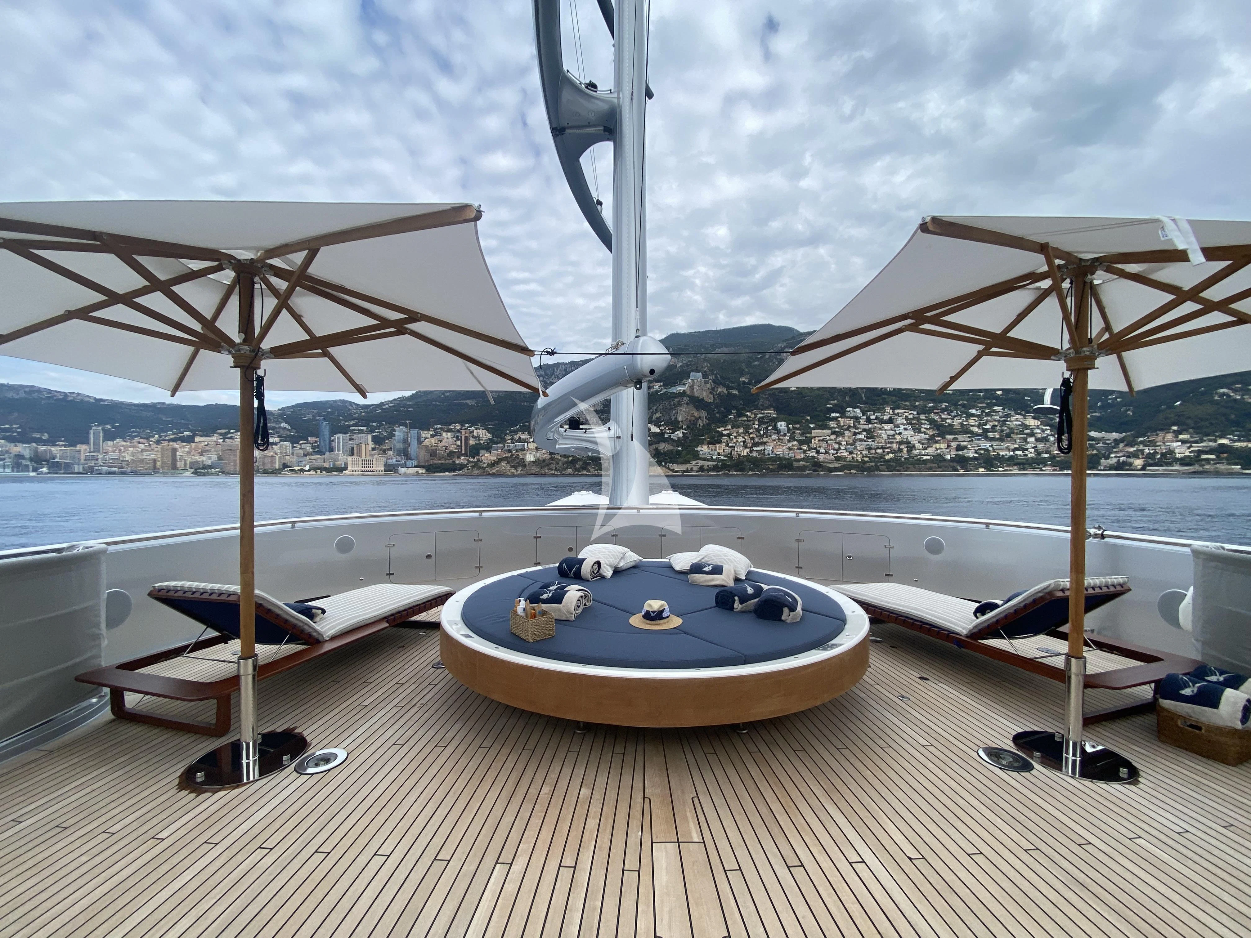 a table with umbrellas on it aboard MALTESE FALCON Yacht for Sale