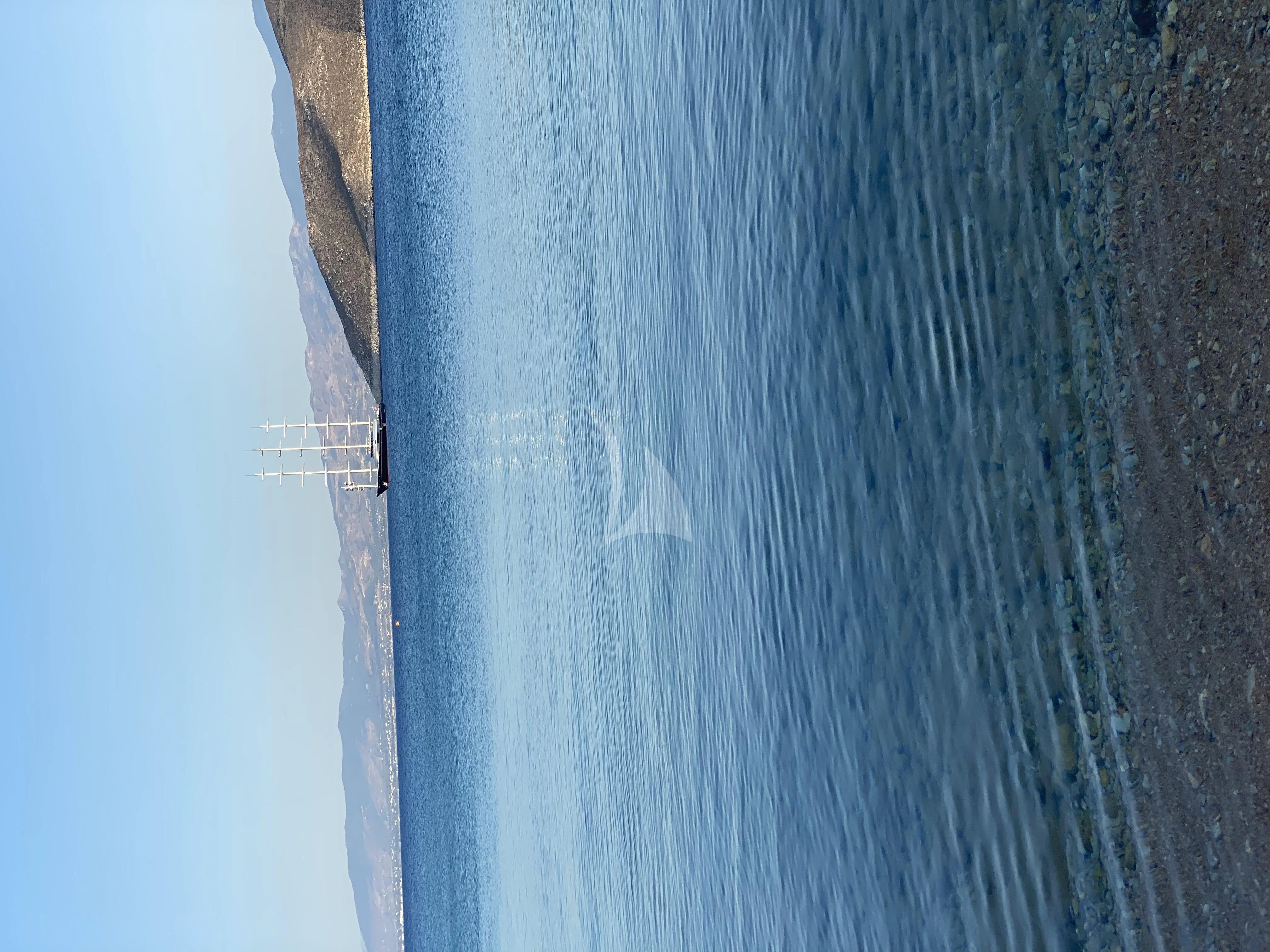 a blue boat on the water aboard MALTESE FALCON Yacht for Sale