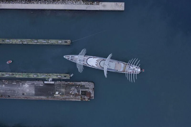 a plane flying over a city aboard MALTESE FALCON Yacht for Sale