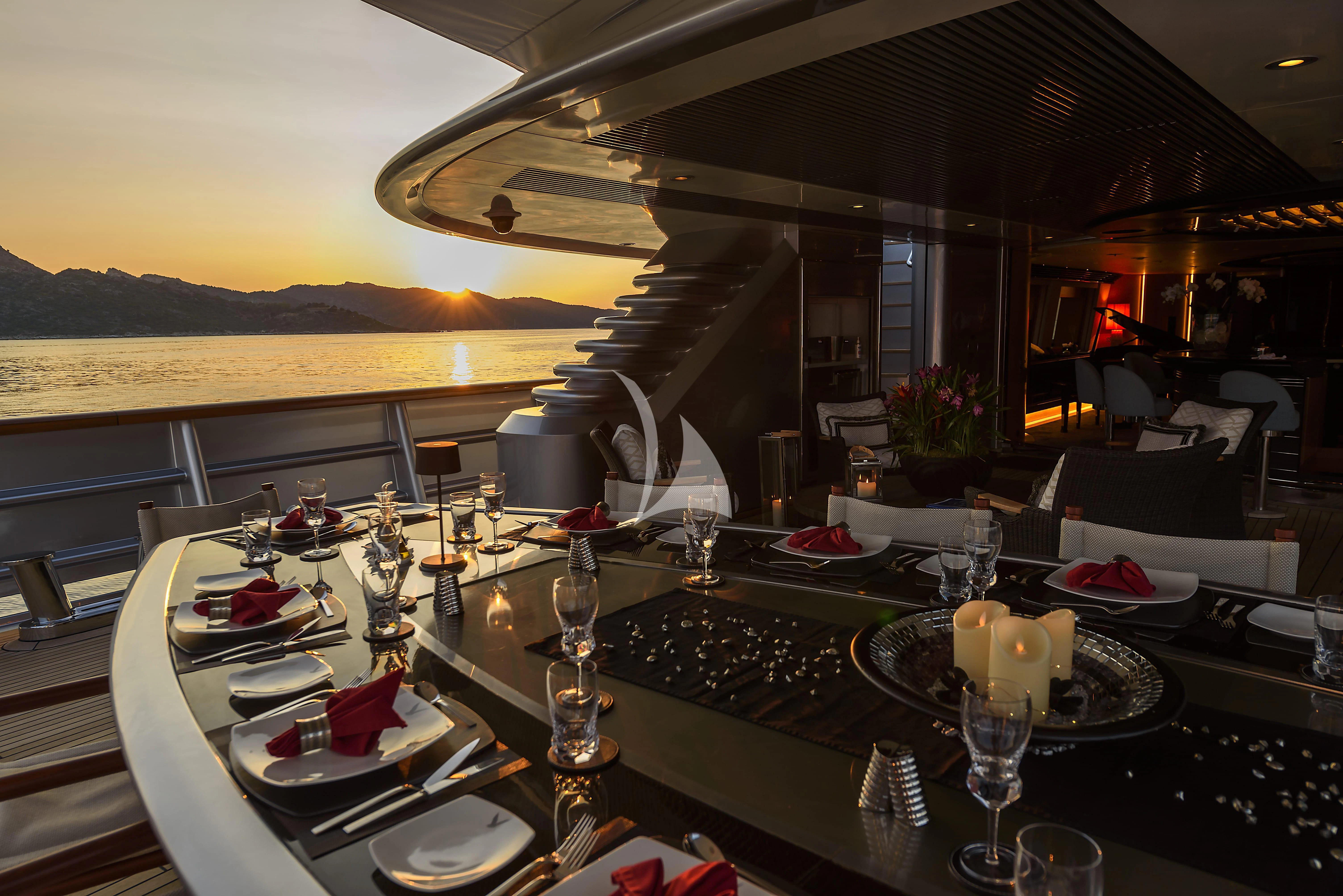a table with plates and glasses aboard MALTESE FALCON Yacht for Sale