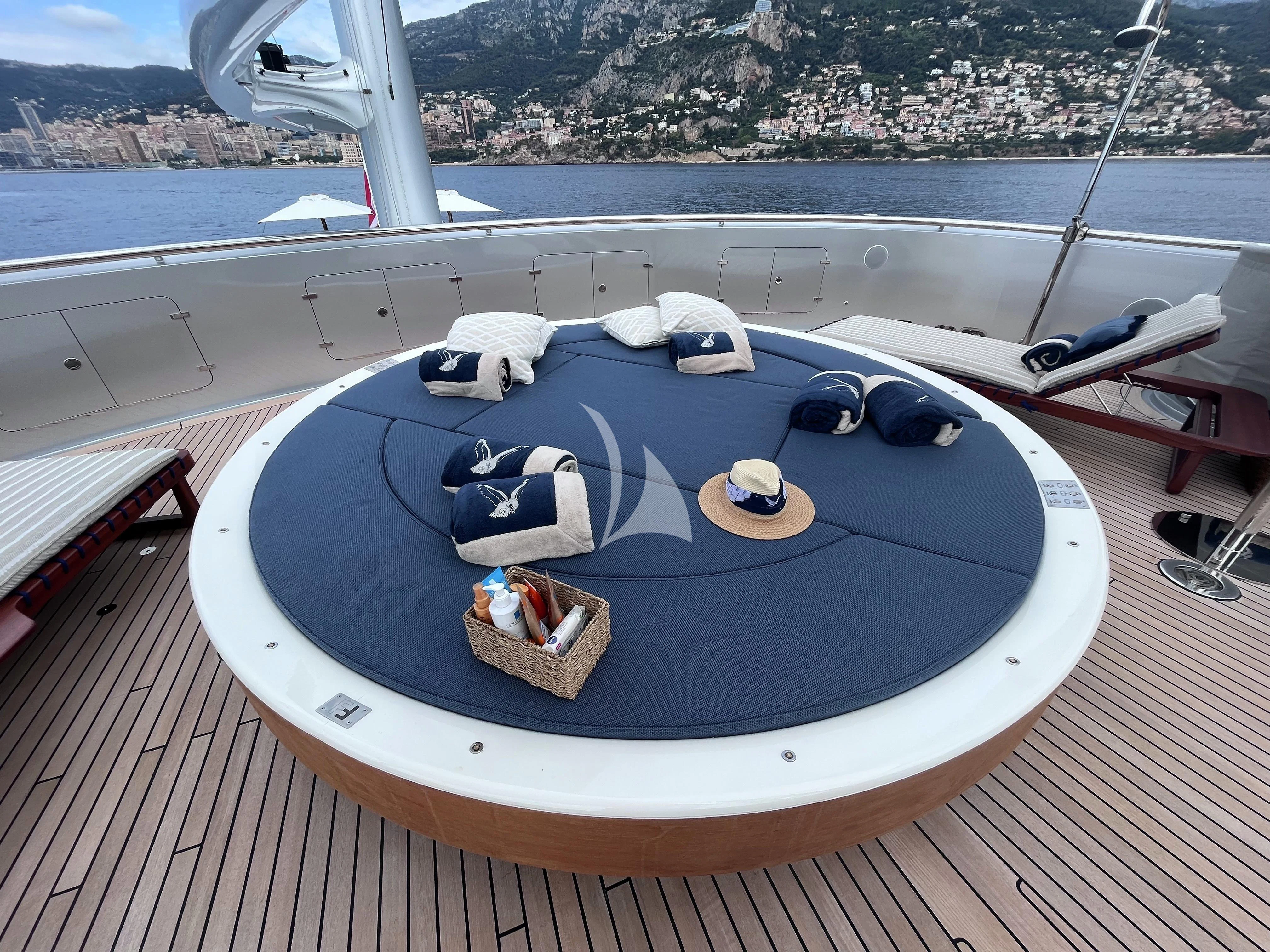 a pool with a deck and a view of a city aboard MALTESE FALCON Yacht for Sale