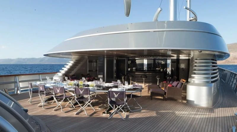 a large patio with tables and chairs aboard MALTESE FALCON Yacht for Sale