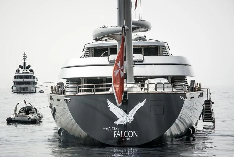 a large ship with a smaller boat in the water aboard MALTESE FALCON Yacht for Sale