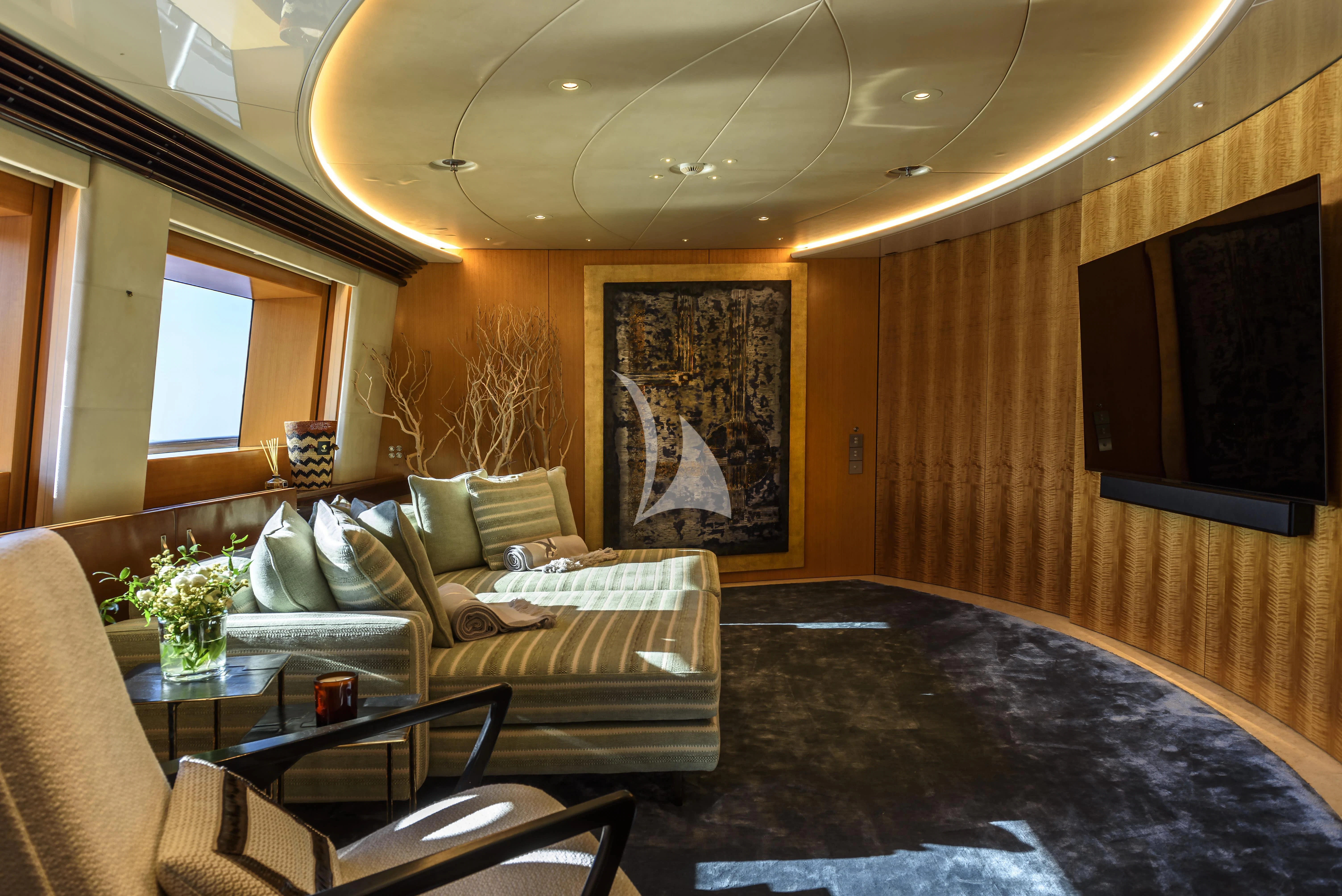 a living room with a couch and a table aboard MALTESE FALCON Yacht for Sale