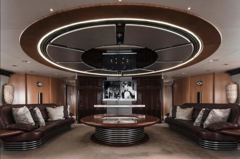 a living room with a large chandelier aboard MALTESE FALCON Yacht for Sale