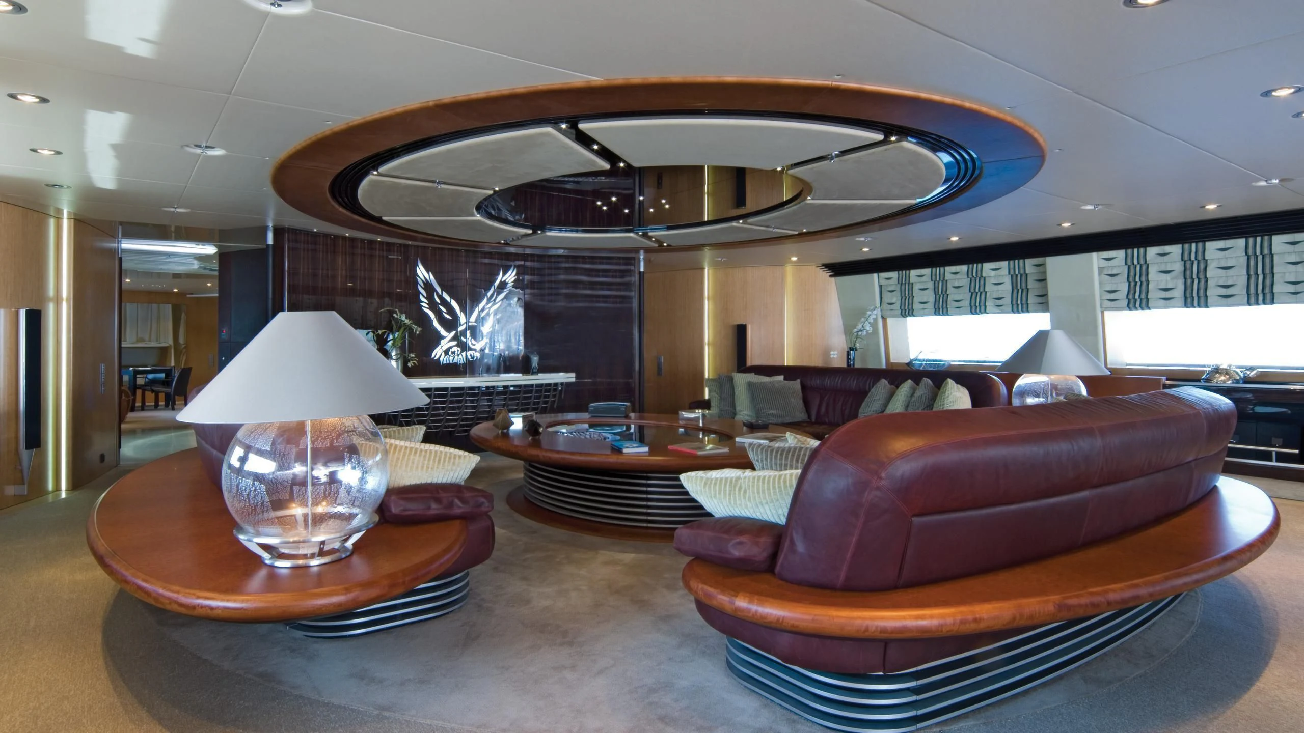 a room with a fireplace and a table with chairs aboard MALTESE FALCON Yacht for Sale