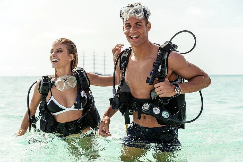 a man and woman in water aboard MALTESE FALCON Yacht for Sale