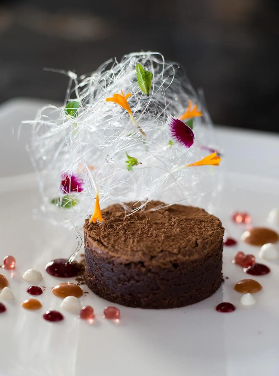 a chocolate cake with a candle on top aboard MALTESE FALCON Yacht for Sale