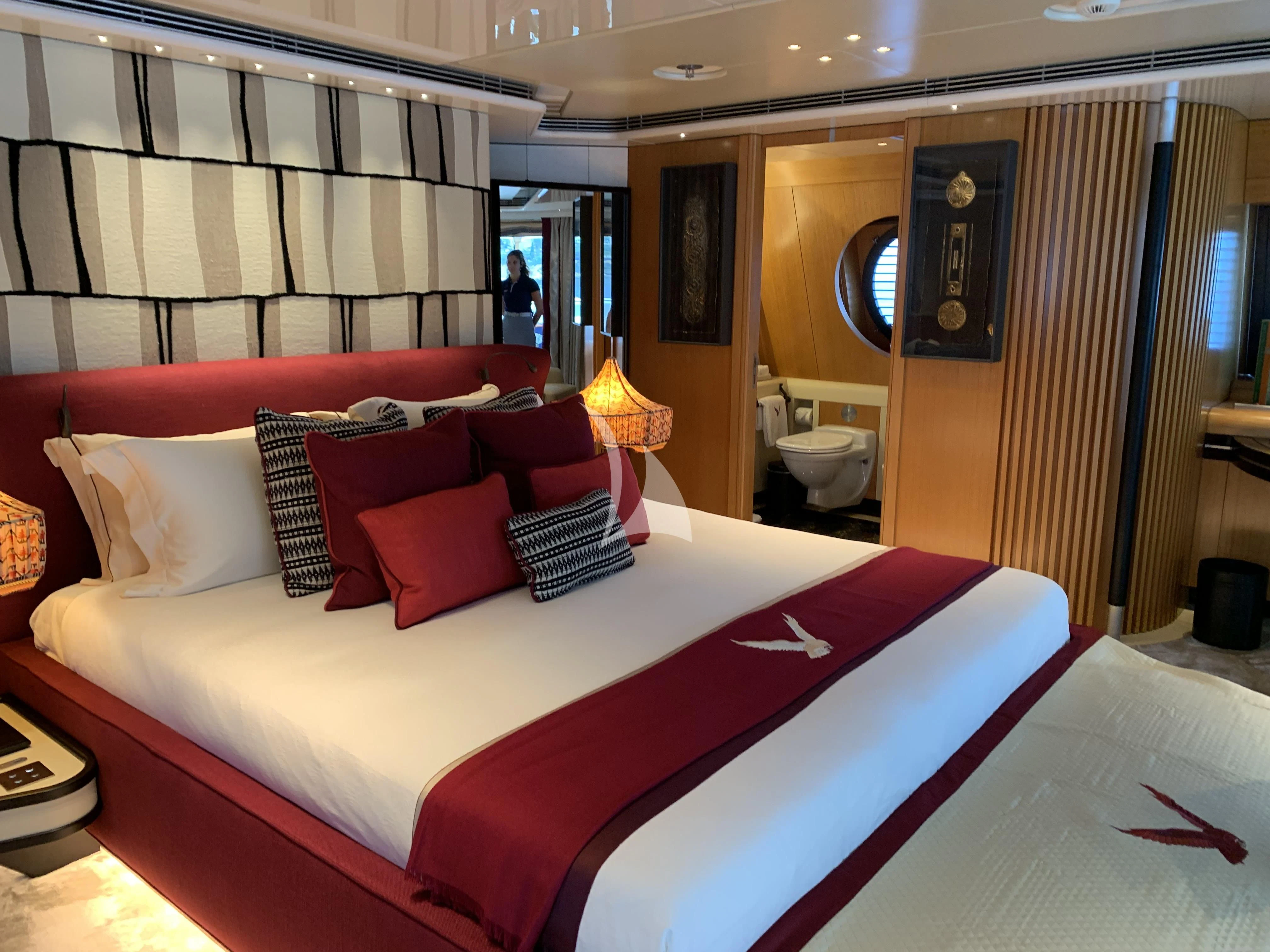 a bed with red and white sheets aboard MALTESE FALCON Yacht for Sale