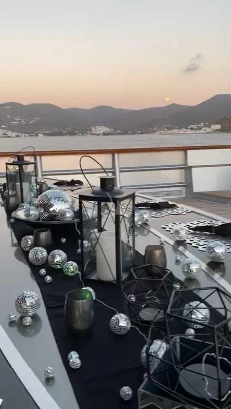 a table with a group of objects on it aboard MALTESE FALCON Yacht for Sale
