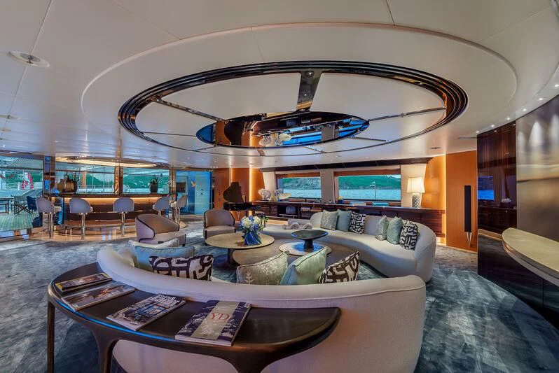 a large living room with a large chandelier aboard MALTESE FALCON Yacht for Sale