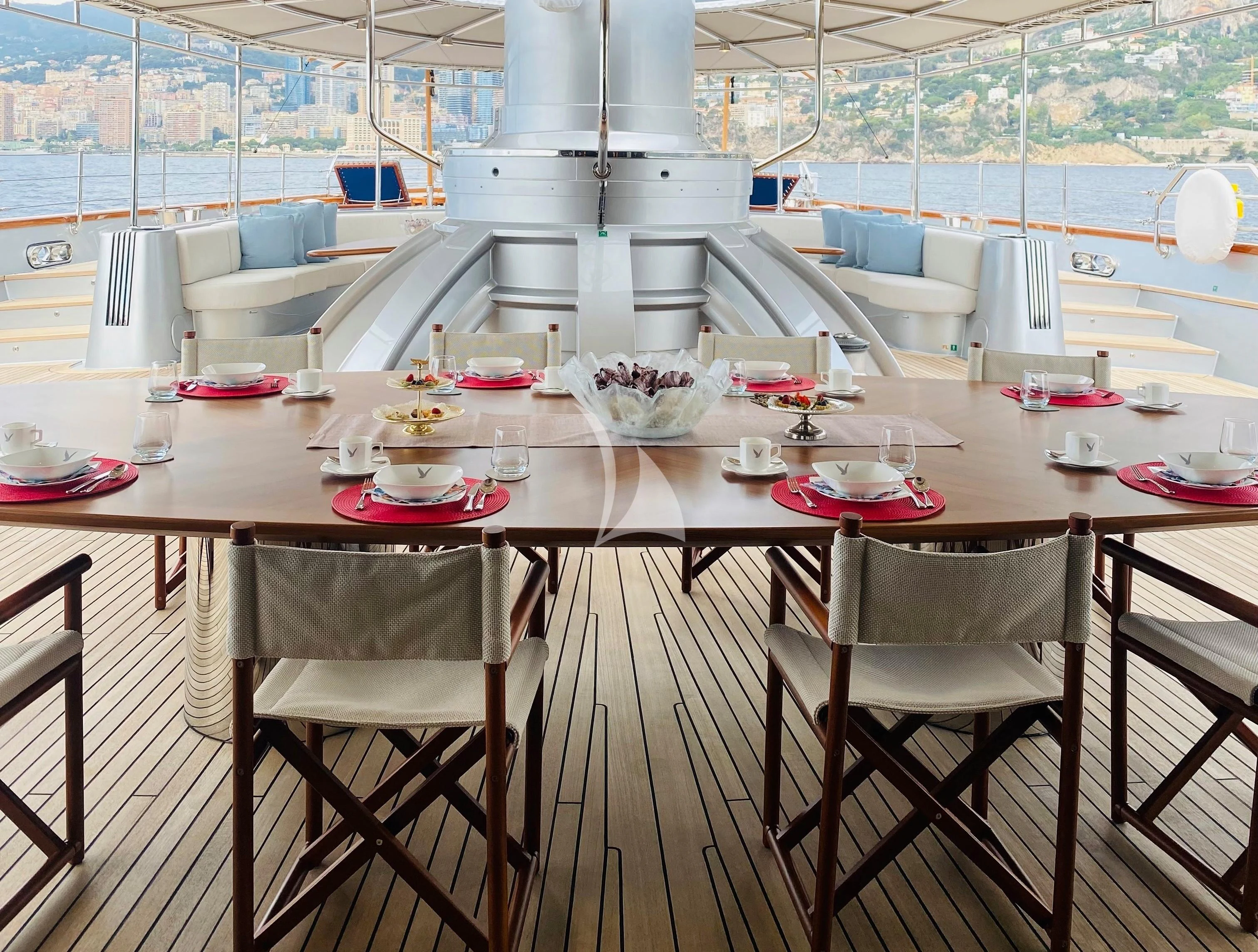 a table with plates and bowls on it aboard MALTESE FALCON Yacht for Sale