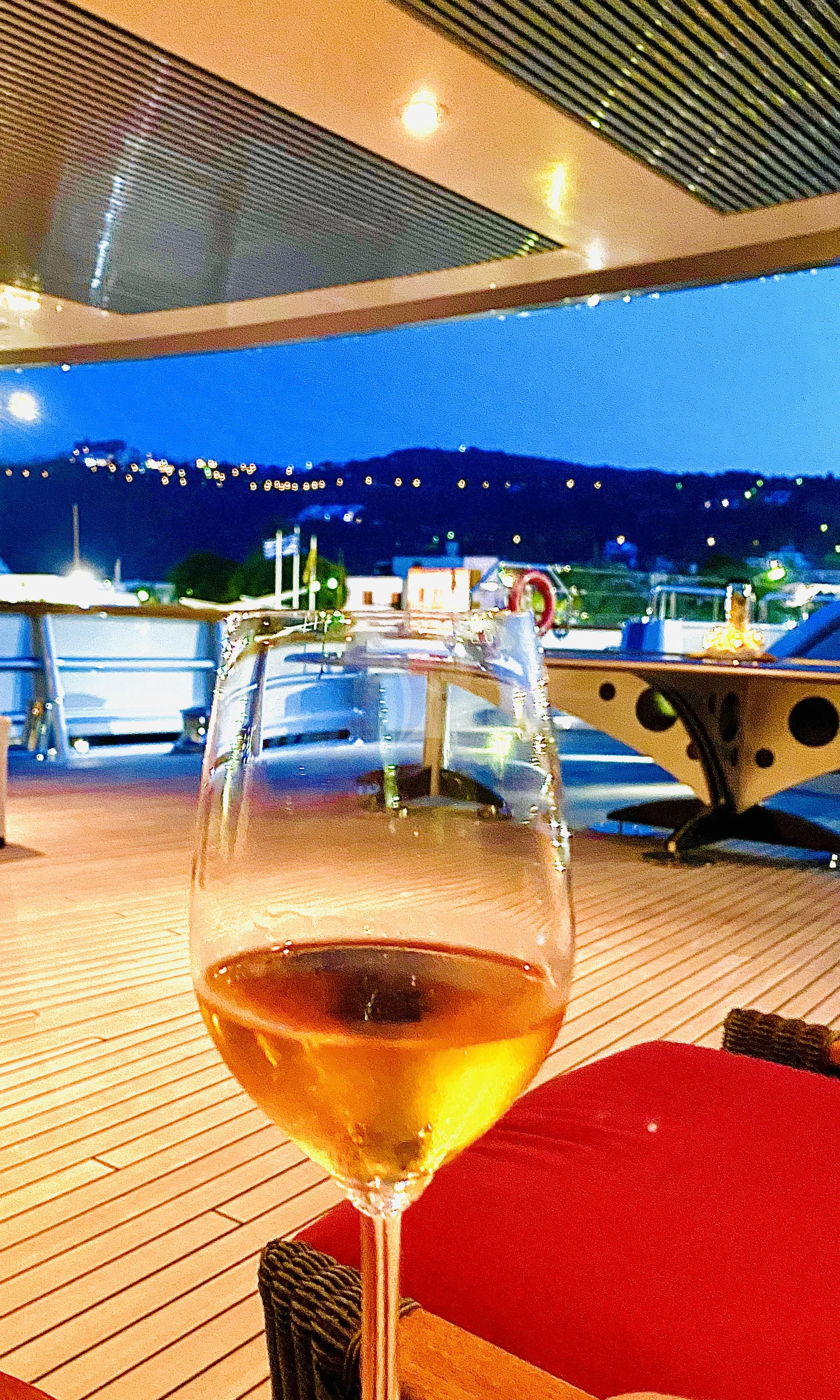 a glass of beer on a table aboard MALTESE FALCON Yacht for Sale