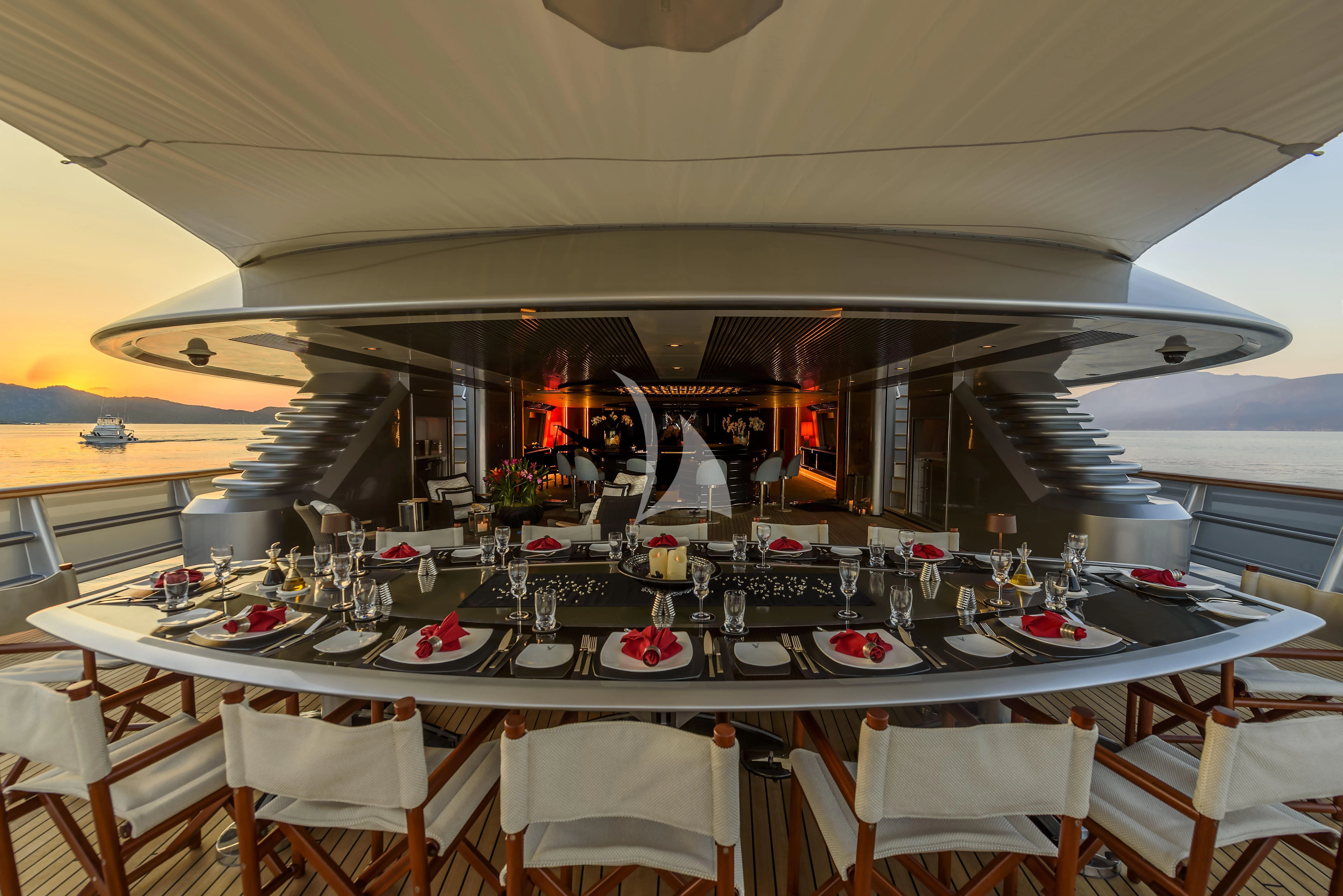 a room with tables and chairs aboard MALTESE FALCON Yacht for Sale