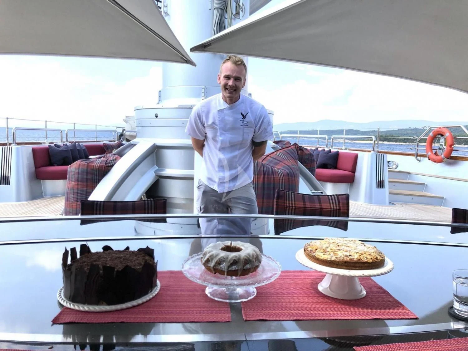 a man standing in front of a cake on a table aboard MALTESE FALCON Yacht for Sale