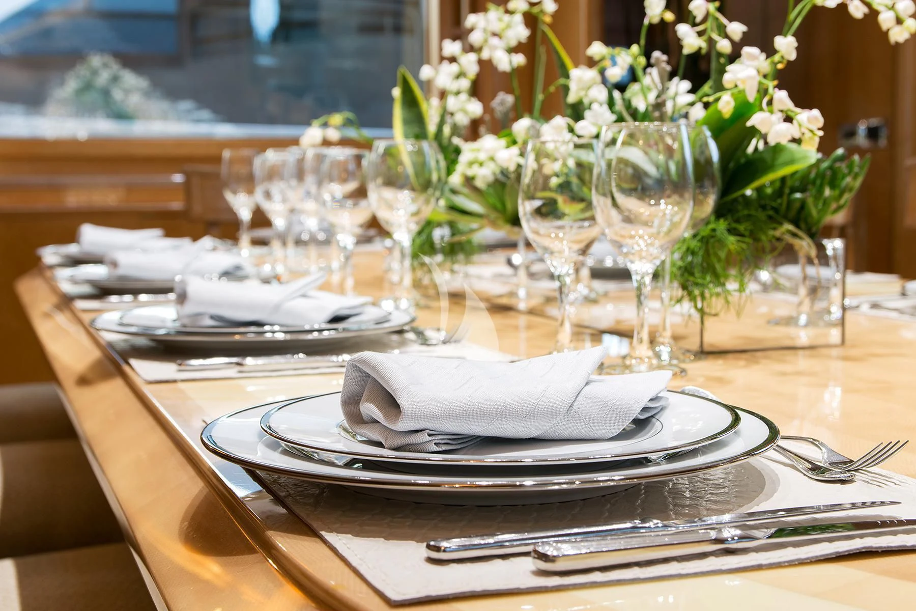 a table with plates and glasses aboard BELLA STELLA Yacht for Charter