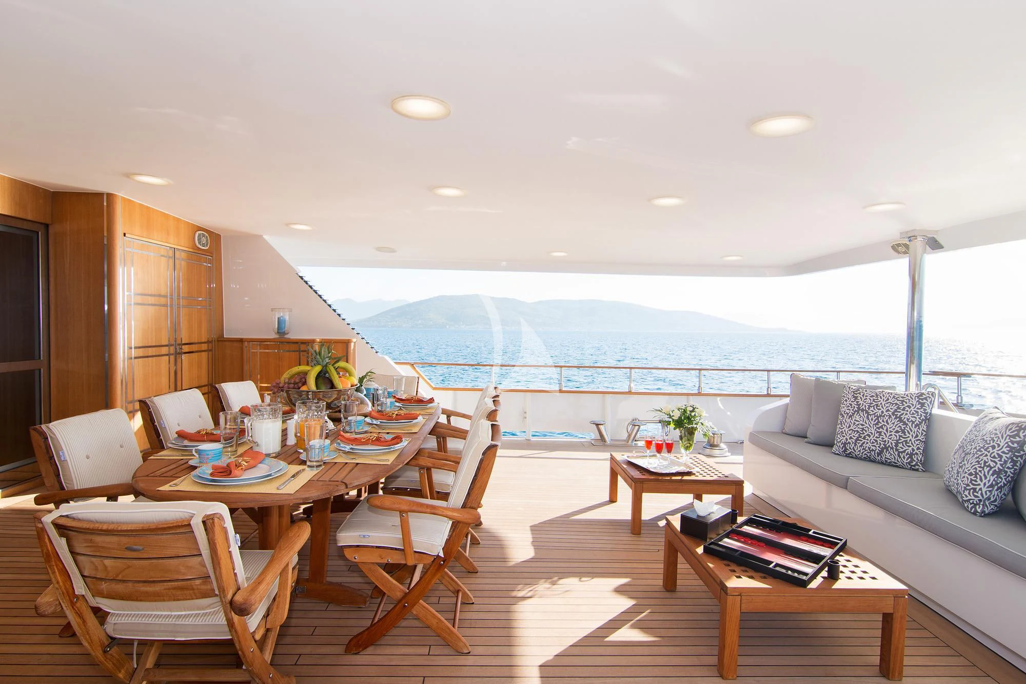 a living room with a large table and chairs aboard BELLA STELLA Yacht for Charter