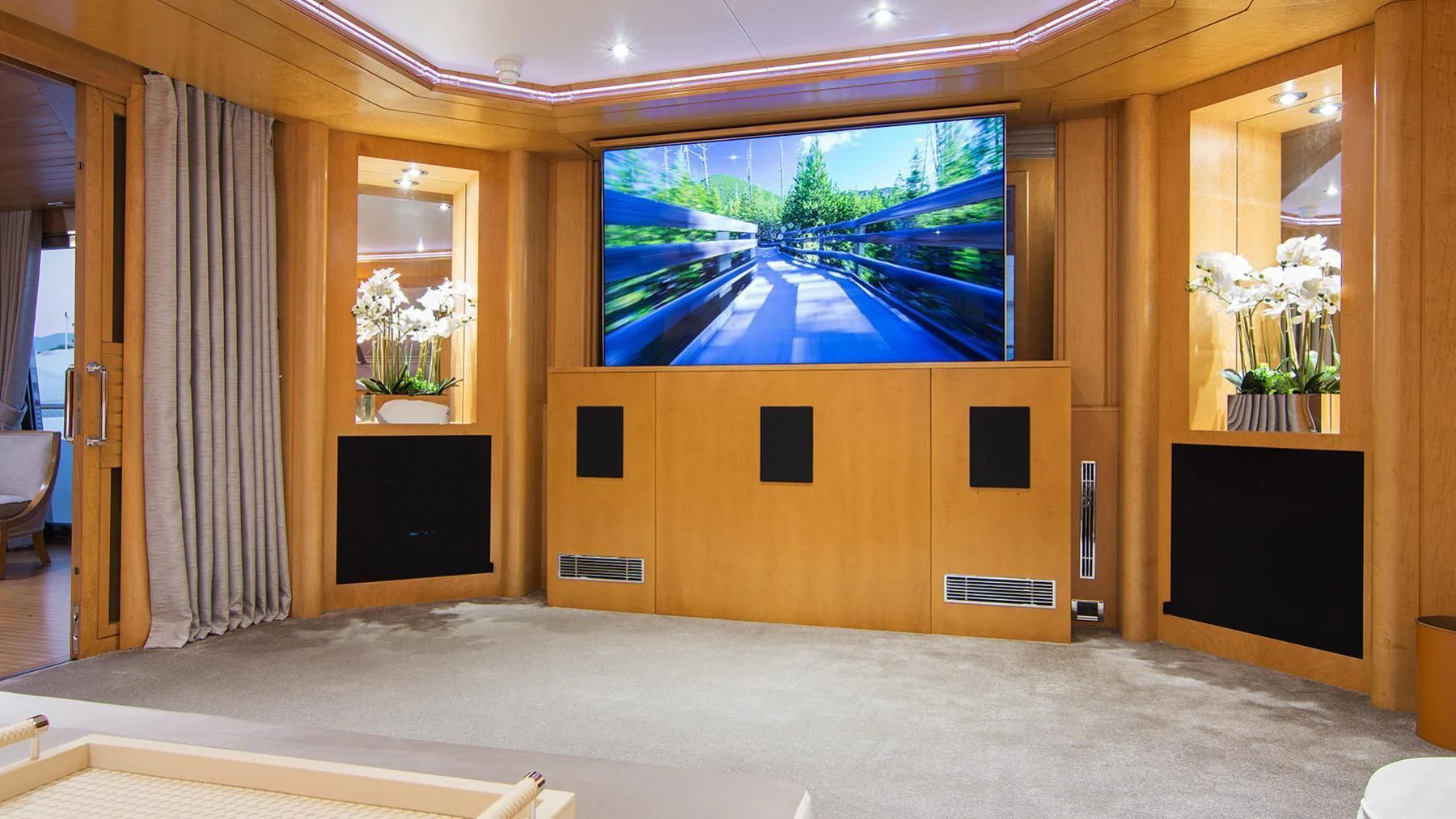 a large room with a large flat screen television and a large window aboard BELLA STELLA Yacht for Charter
