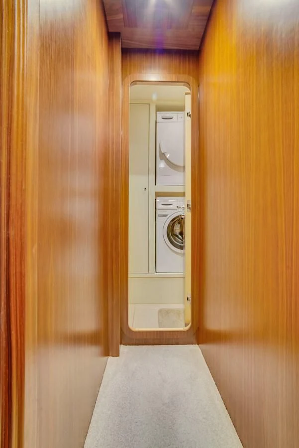 a closet with a washer and dryer in it aboard ALEGRA Yacht for Sale