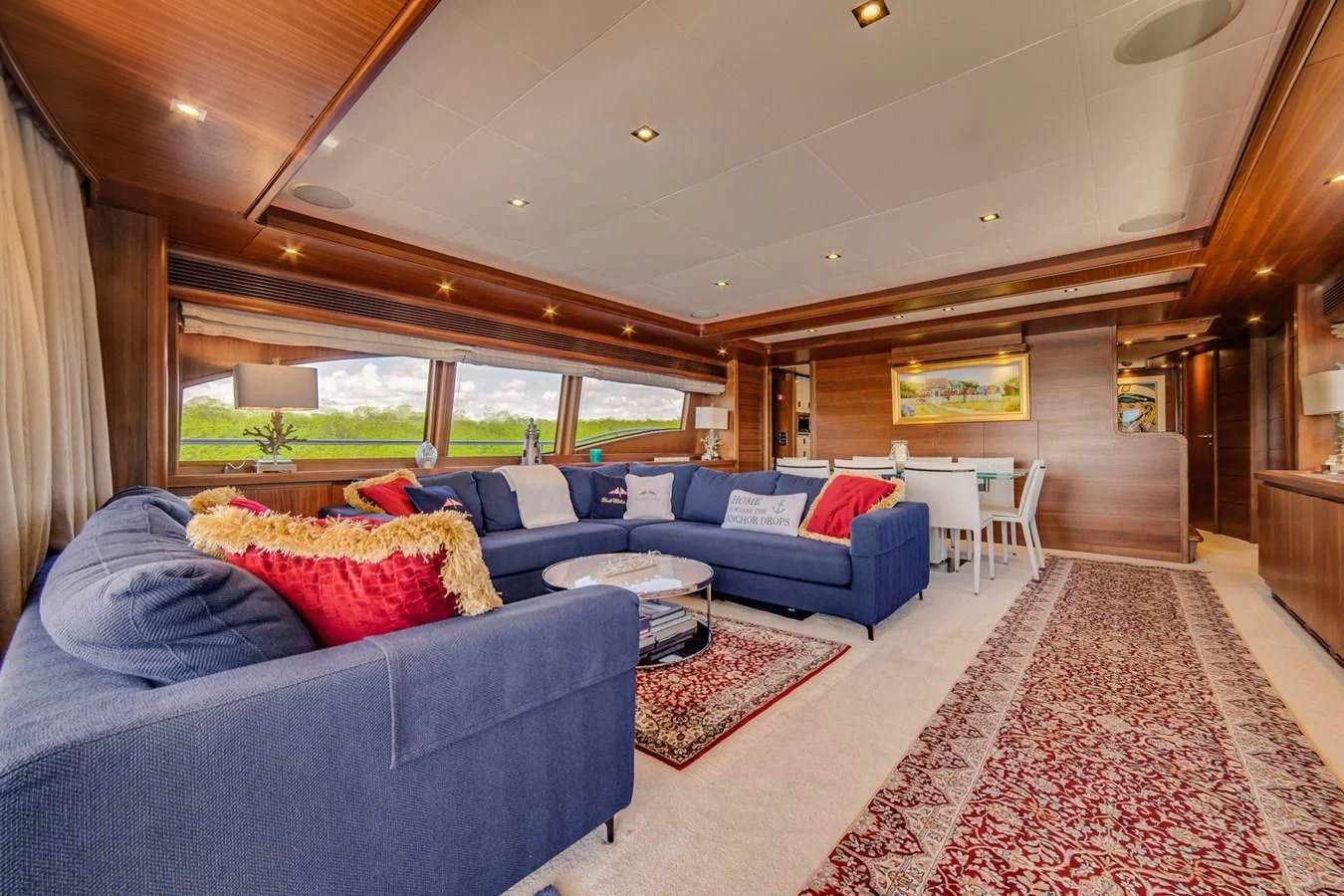a living room with a blue couch aboard ALEGRA Yacht for Sale