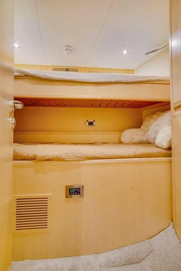 a bunk bed with a sign on the wall aboard ALEGRA Yacht for Sale