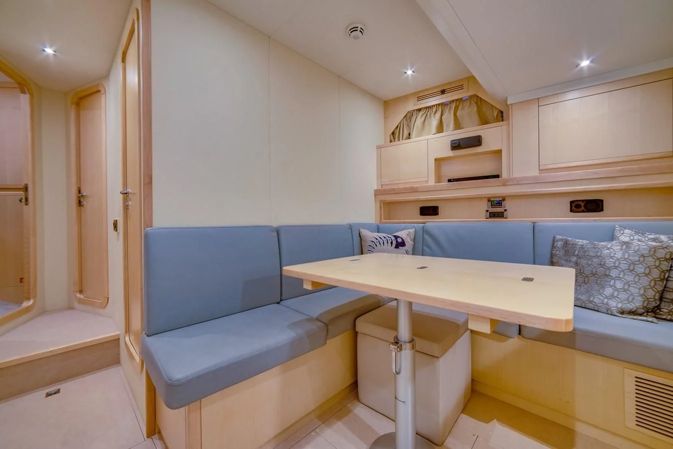 a room with a table and couch aboard ALEGRA Yacht for Sale