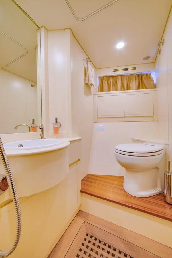 a bathroom with a toilet sink and a mirror aboard ALEGRA Yacht for Sale