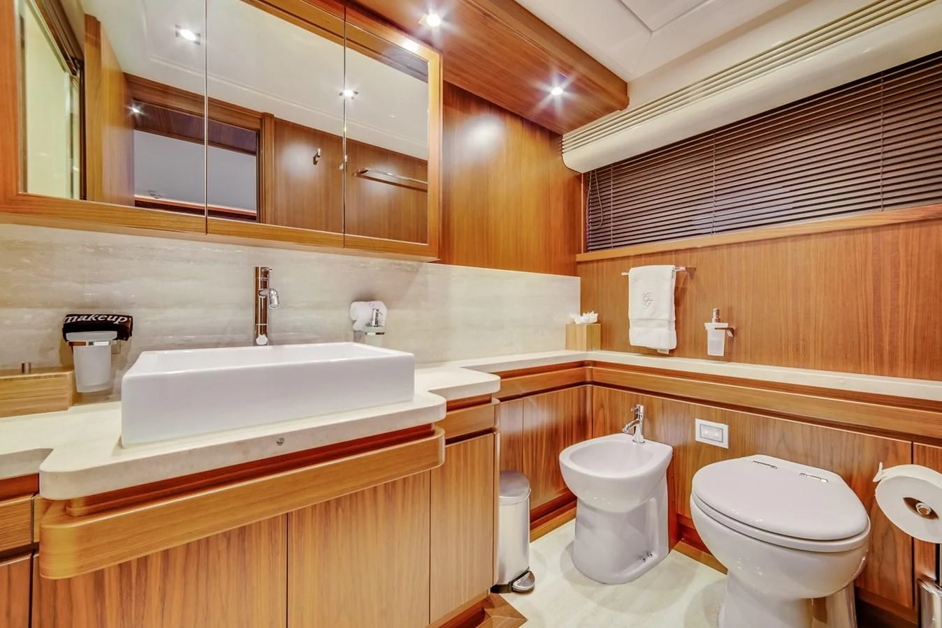 a bathroom with wooden cabinets aboard ALEGRA Yacht for Sale