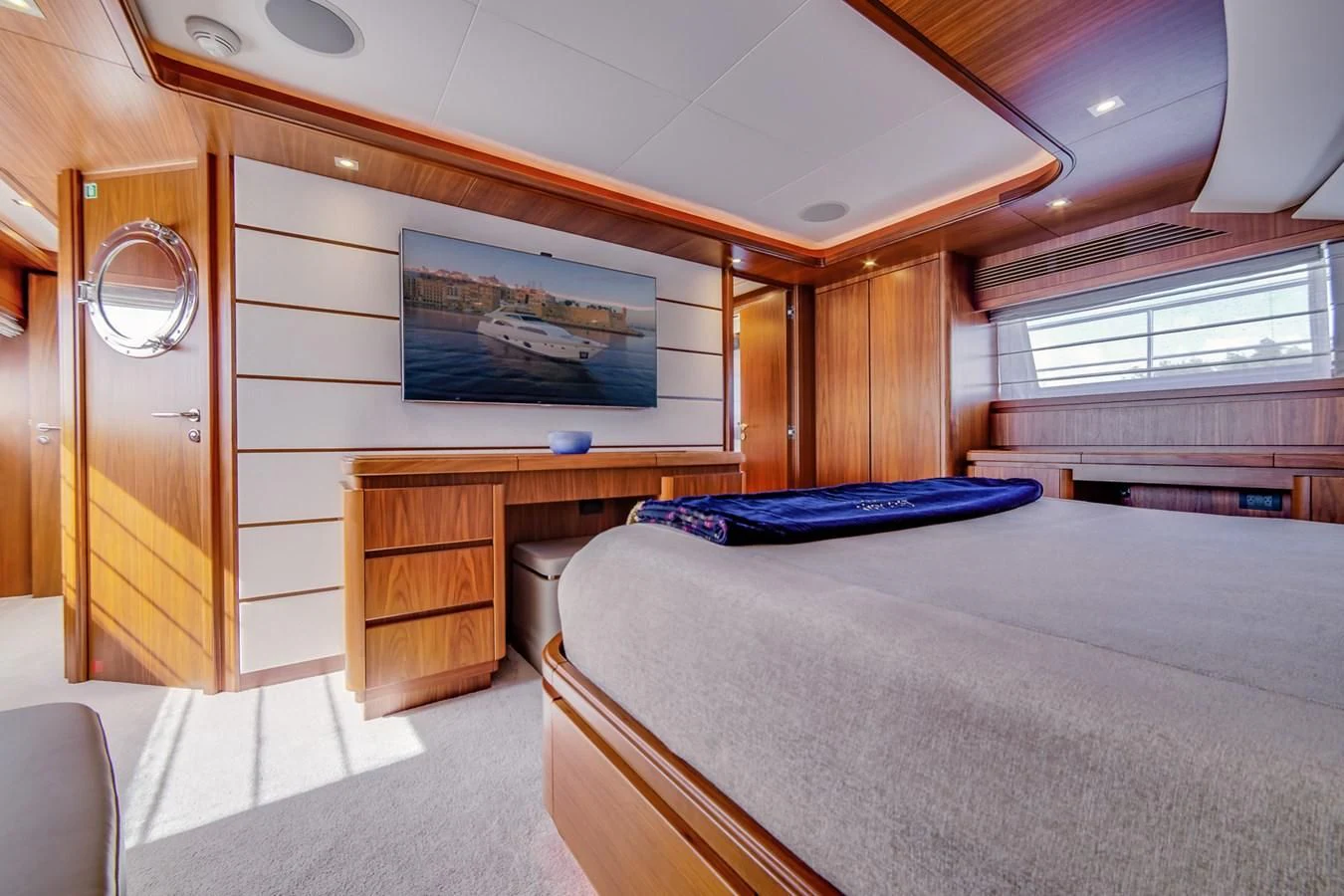 a bedroom with a bed and a desk aboard ALEGRA Yacht for Sale