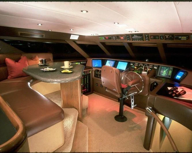 a room with a table and chairs aboard PIPELINER Yacht for Sale
