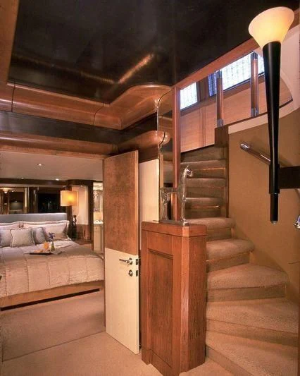 a bedroom with a bed and a staircase aboard PIPELINER Yacht for Sale