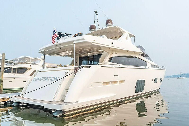 a white boat on the water aboard TEMPTATION Yacht for Sale