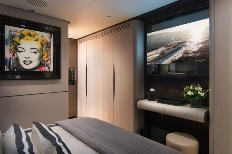 a room with a bed and a television aboard MEMORIES TOO Yacht for Sale