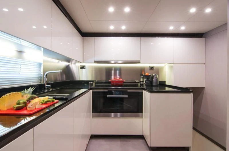 a kitchen with white cabinets aboard MEMORIES TOO Yacht for Sale