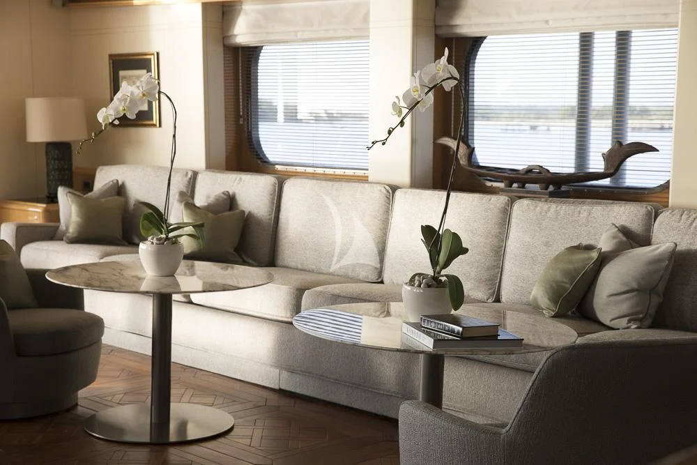 a living room with a couch and coffee table aboard AQUA BLU Yacht for Sale