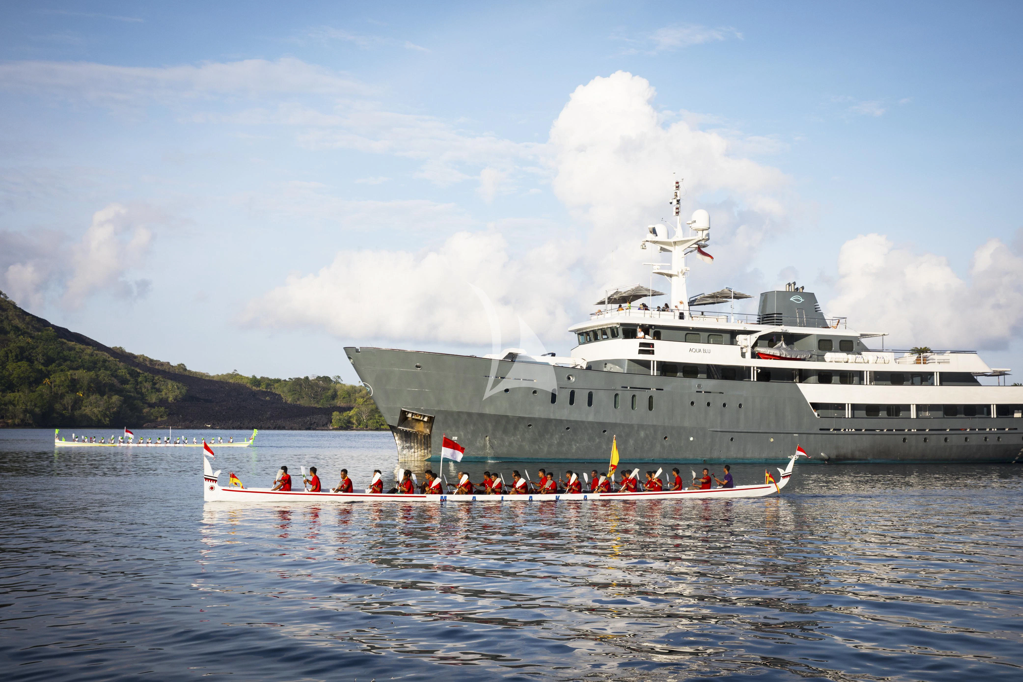 a large ship in the water aboard AQUA BLU Yacht for Sale
