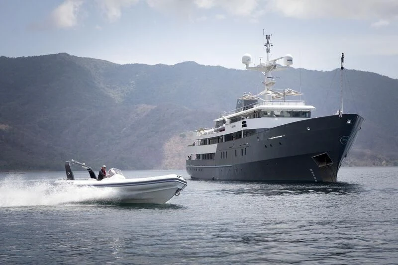 a large ship in the water aboard AQUA BLU Yacht for Sale