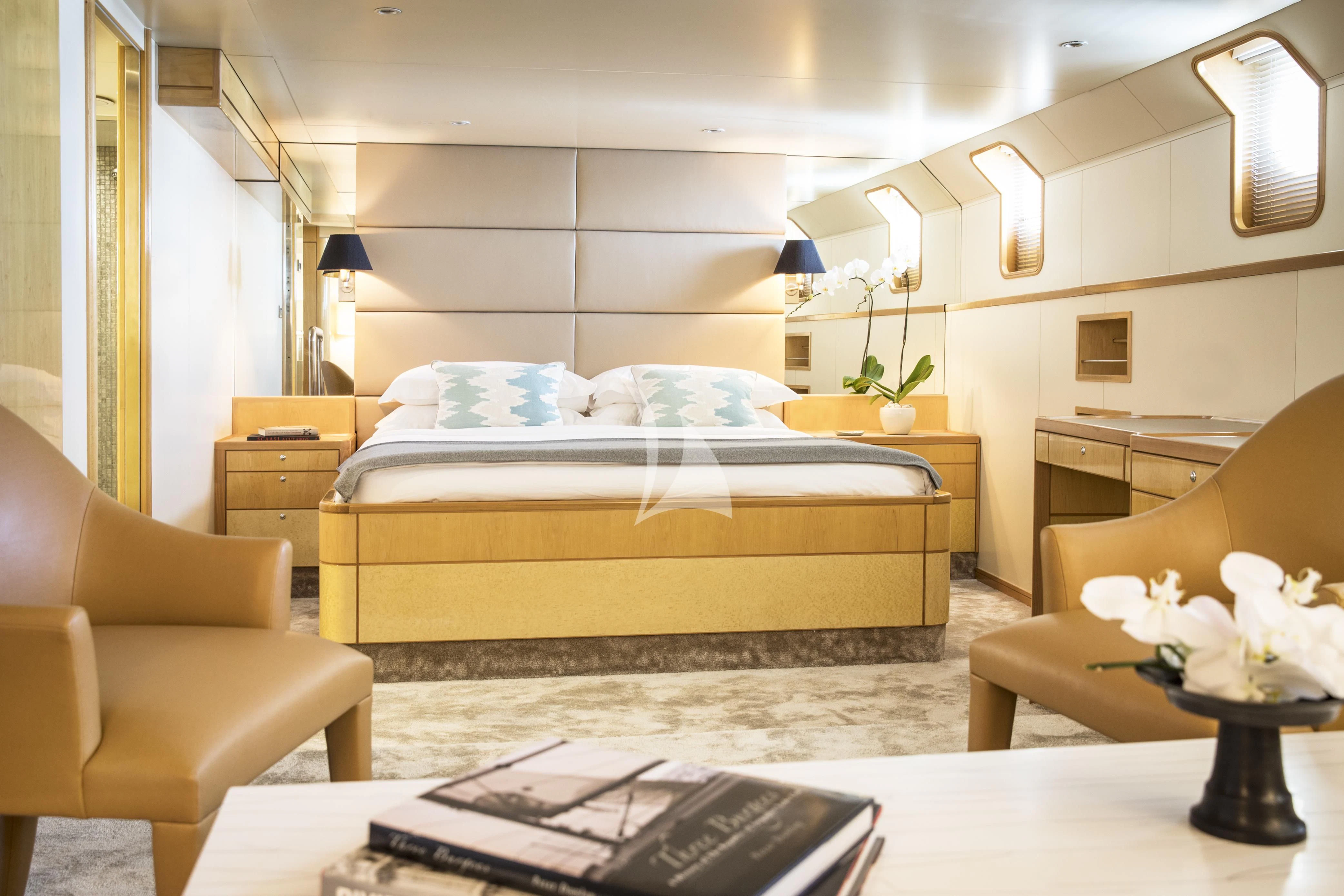 a bedroom with a bed and a desk aboard AQUA BLU Yacht for Sale