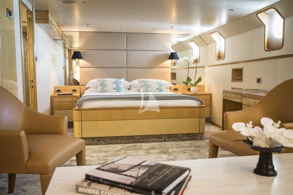 a bedroom with a bed and a desk aboard AQUA BLU Yacht for Sale