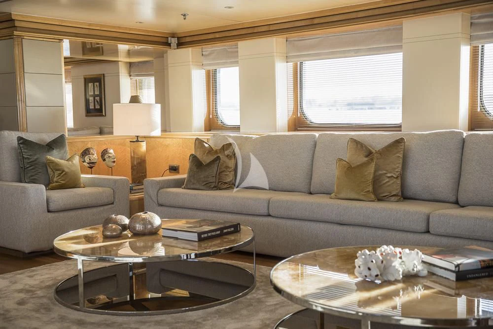a living room with a couch and coffee table aboard AQUA BLU Yacht for Sale