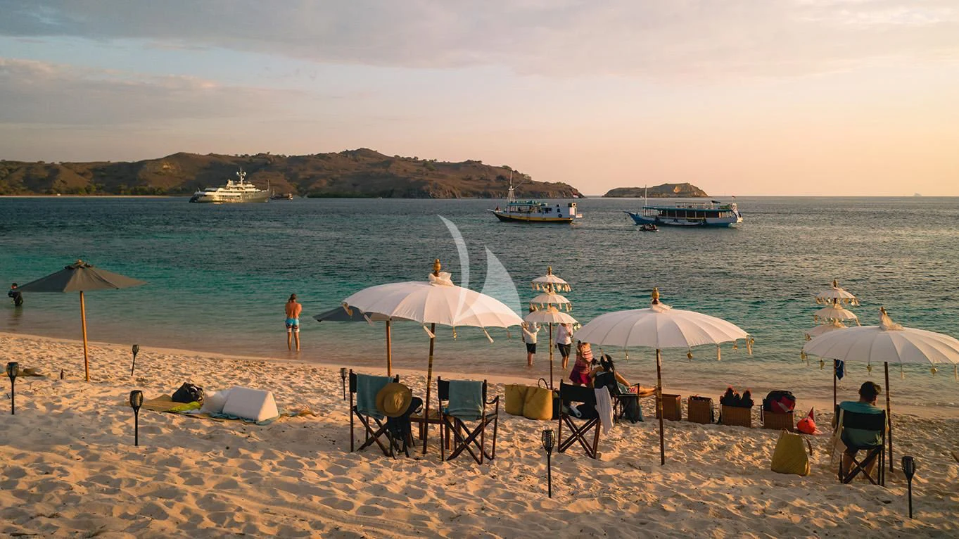 a beach with chairs and umbrellas aboard AQUA BLU Yacht for Sale