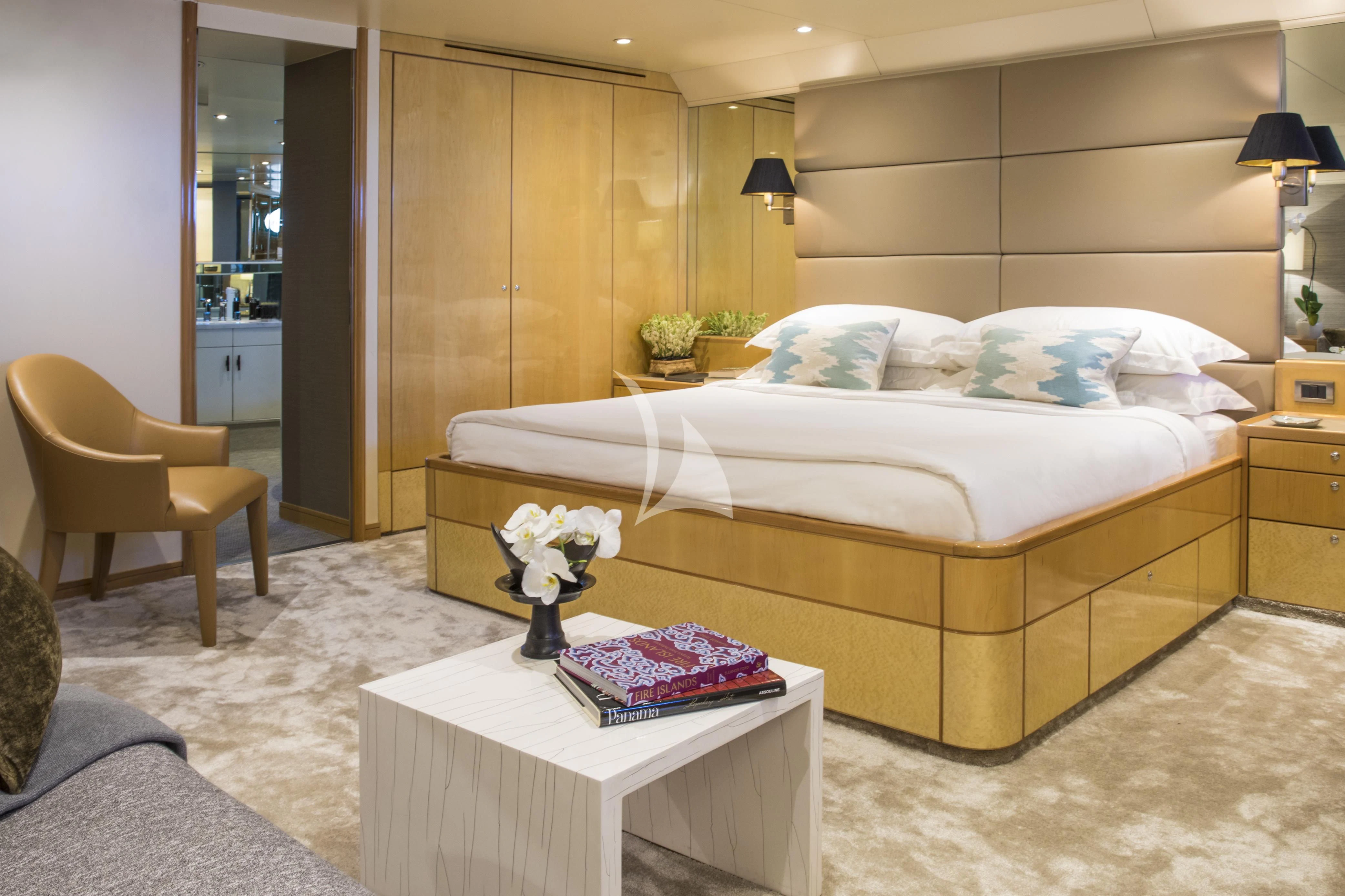 a bedroom with a bed and a chair aboard AQUA BLU Yacht for Sale